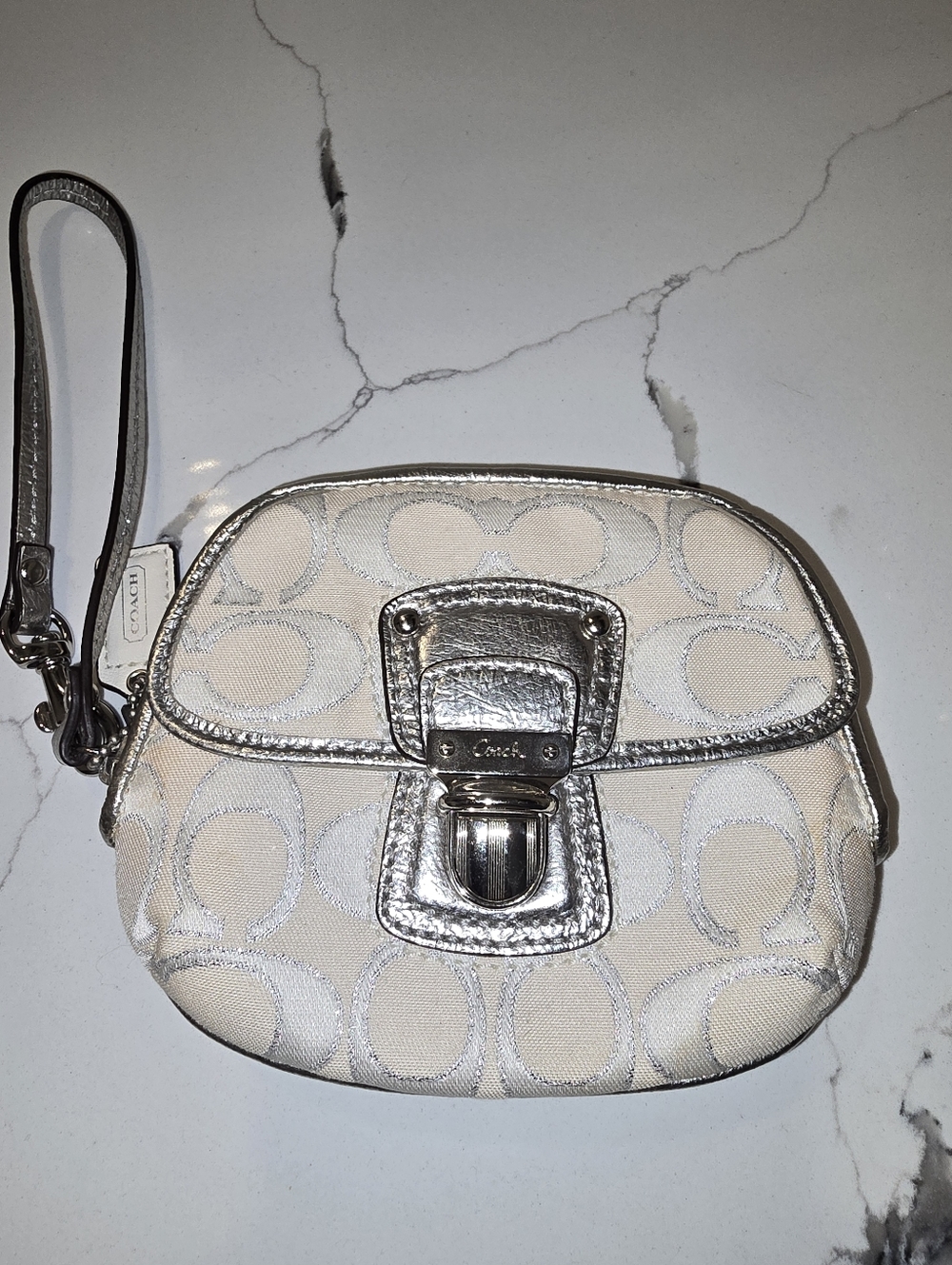 Coach signature jacquard cream and silver wristlet with a front clasp